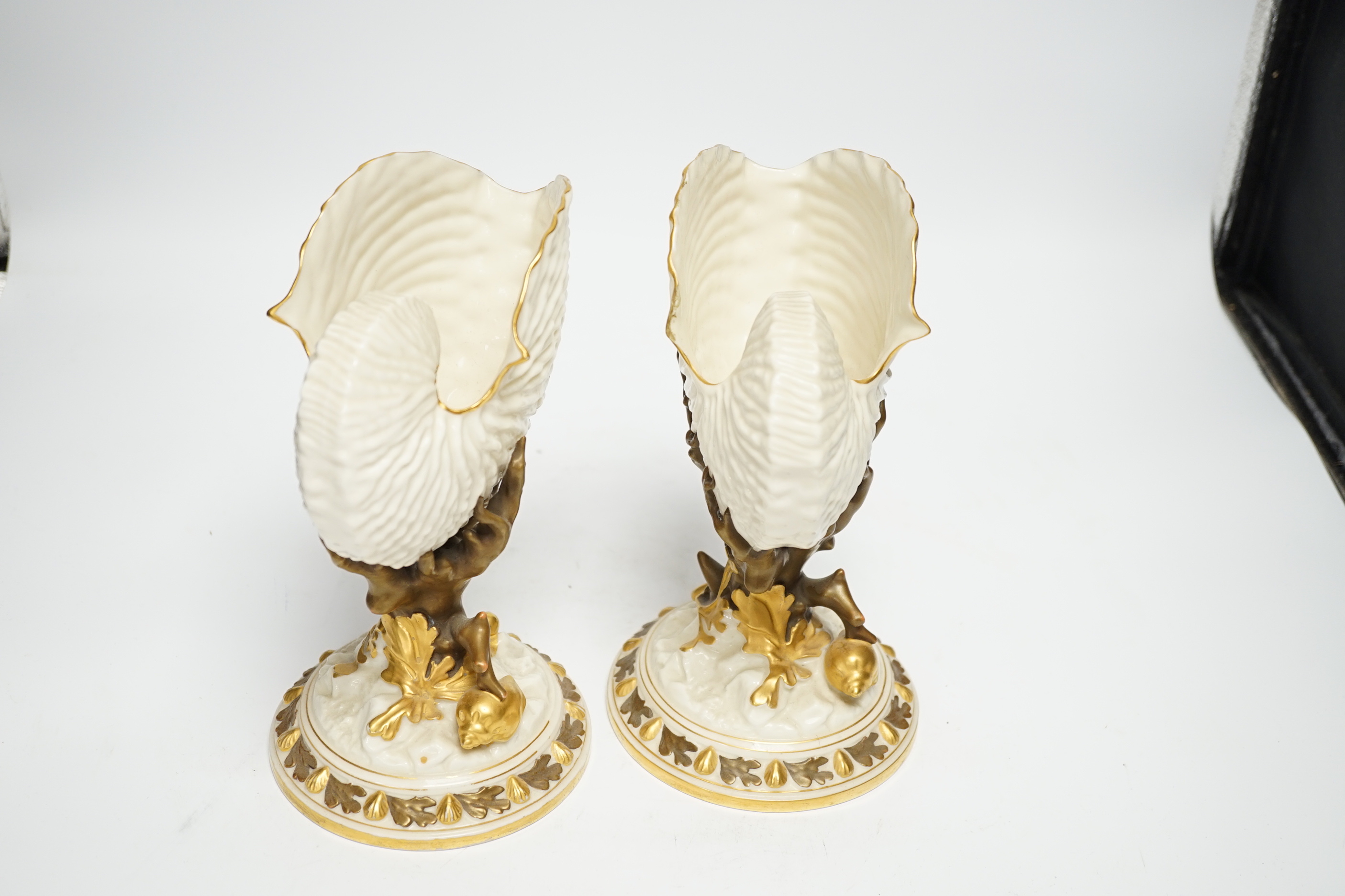 A pair of Royal Worcester “nautilus” vases, 22cm high